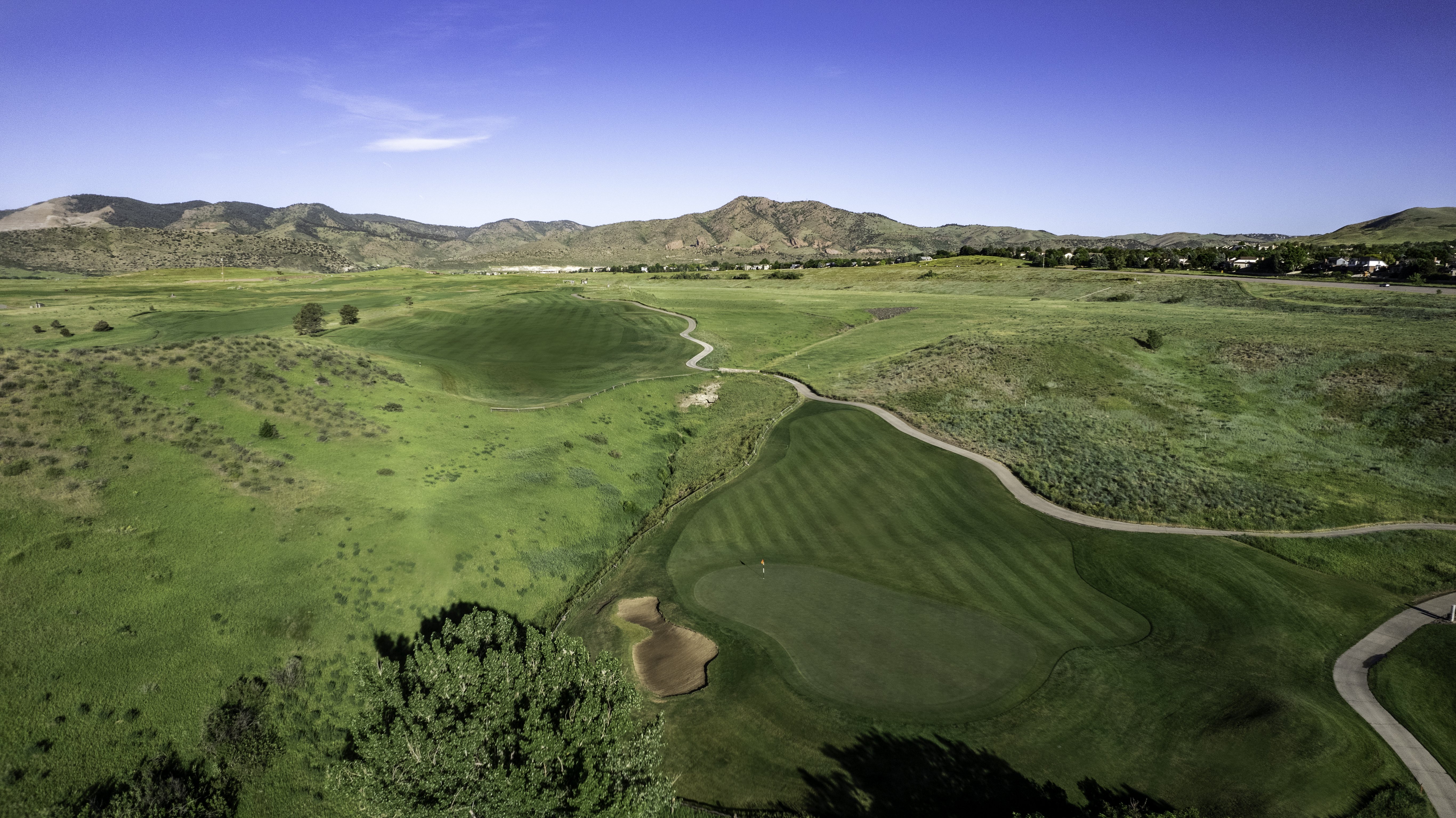 aerial view of Fox Hollow's Canyon #6 with Rocky Mountains in the background